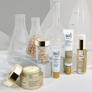 stylized retinol correxion products posed infront of beakers