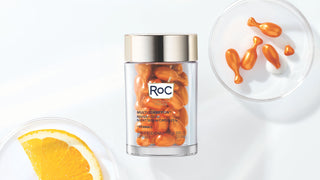 MULTI CORREXION® REVIVE + GLOW VITAMIN C NIGHT SERUM CAPSULES on a white background with the capsules and an orange peel on petri dishes. Click here to shop the offer.