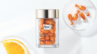 MULTI CORREXION® REVIVE + GLOW VITAMIN C NIGHT SERUM CAPSULES on a white background with the capsules and an orange peel on petri dishes. Click here to shop the offer.