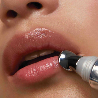 Model lips using Lip Volumizer applicator to apply product